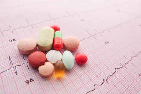 prescription medical pills on a cardio diagram.の写真素材