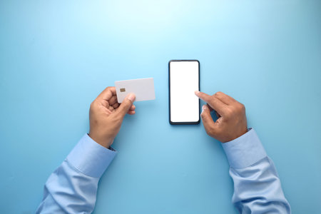 Man hand holding credit card and using smart phone shopping online