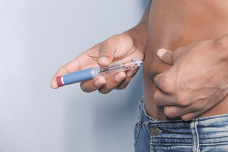 young man hand using insulin pen close up