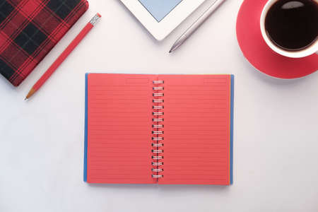 open notepad with stationary on white backgroundの写真素材