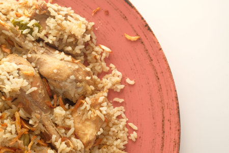 chicken biryani meal in a bowl on table.