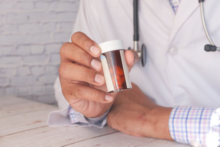 doctor hand holding pill container with copy spaceの写真素材