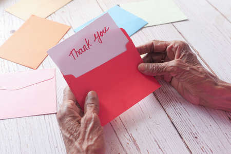 senior womens hand holding thank you letter , rear viewの写真素材