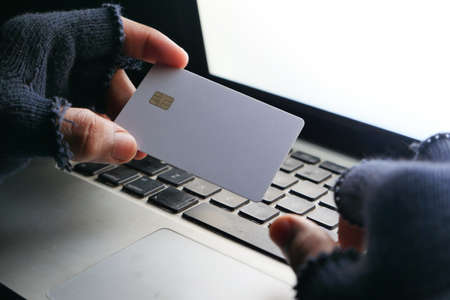 hacker hand stealing data from credit cardの写真素材