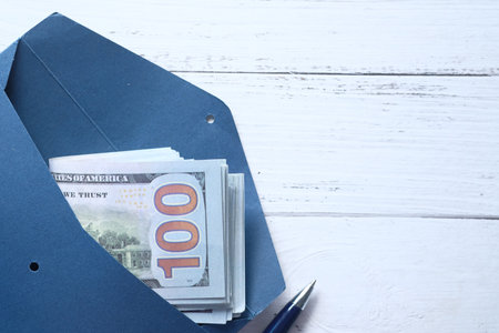 Close up of us dollar cash in a envelope on tableの写真素材