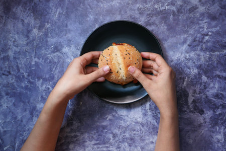 hand holding beef burger on table close upの写真素材