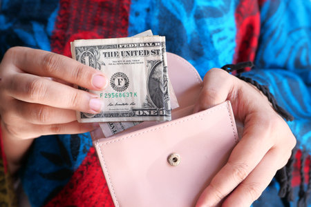 Close up of women hand saving cash in wallet