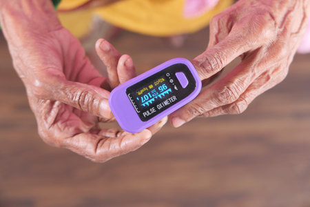 senior women hand using pulse oximeter