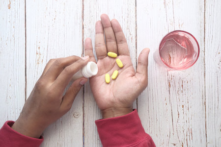 Close up of man hand taking medicineの写真素材