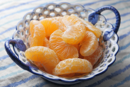 close up of slice of orange fruit in a bowlの写真素材