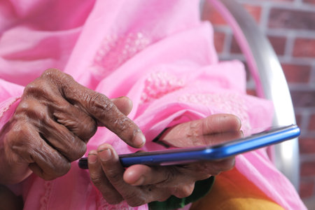 senior women hand using smart phone close upの写真素材