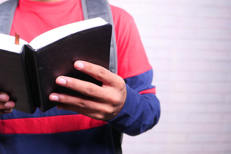 unrecognized man reading a book with copy spaceの写真素材