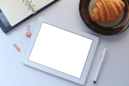 top view of digital tablet with office suppliers on table