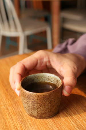 women hand holding a cup of green teaの写真素材