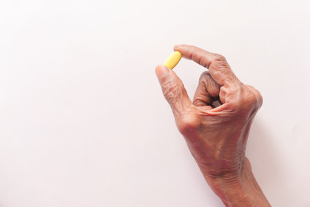 senior hand holding pills with copy spaceの写真素材
