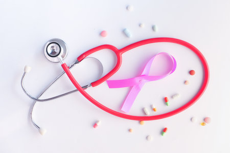 pink ribbon, pills and stethoscope on white background.の写真素材