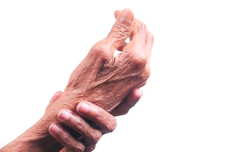 Elderly woman suffering from pain isolated on whiteの写真素材