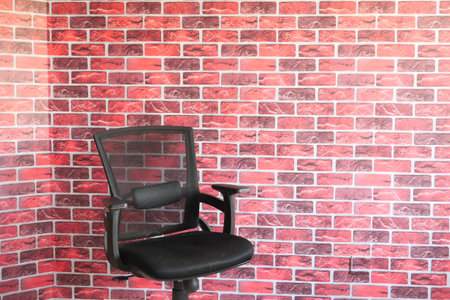 black empty chair against a wall indoorの写真素材