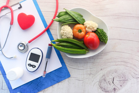diabetic measurement tools and fresh vegetable on tableの写真素材