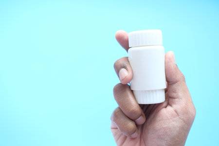 person hand holding pill containerの写真素材