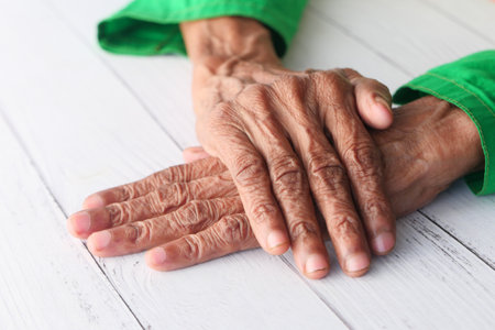 close up of hand of a elderly person isolated on white tableの写真素材