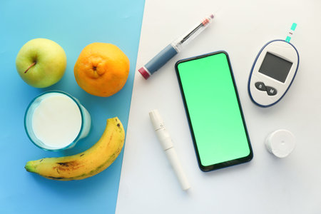 diabetic measurement tools, fruits, smart phone and insulin on tableの写真素材