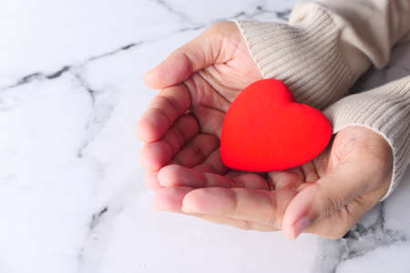 women holding red heart close up .の写真素材