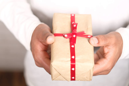 close up of mans hand holding a gift box with copy spaceの写真素材
