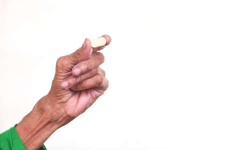 elderly women hand holding pills with copy spaceの写真素材
