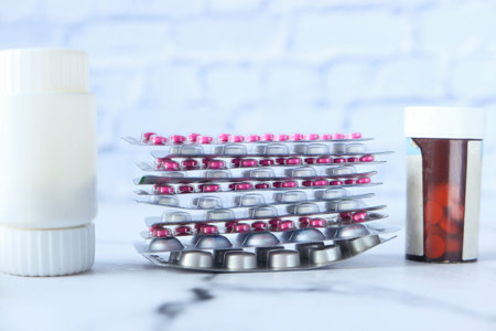 stack of pills of blister pack and container on table