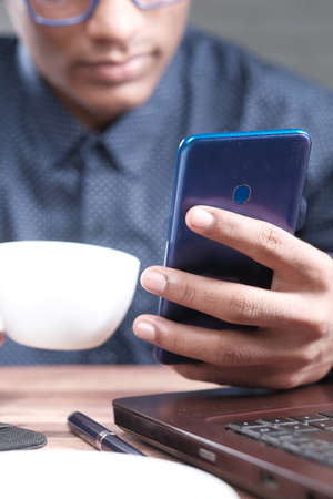 Close up of young man hand using smart phone.の写真素材