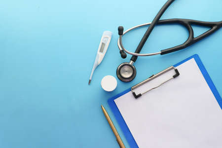 stethoscope, paper, pills and thermometer clinic deskの写真素材