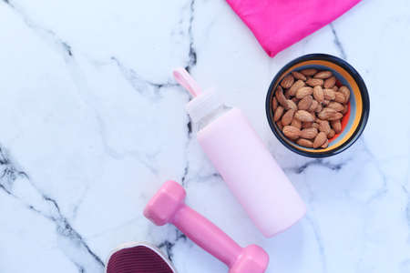 Diet plan with almond nut, dumbbells, banana on table .の写真素材