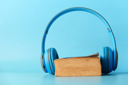 Audio book concept. Headphones and notepad on white background