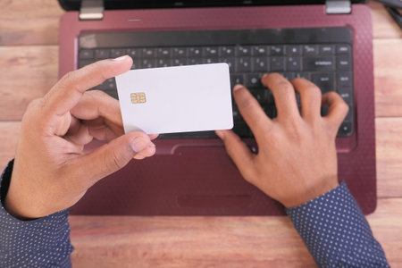 man hands holding credit card and using laptop shopping onlineの写真素材