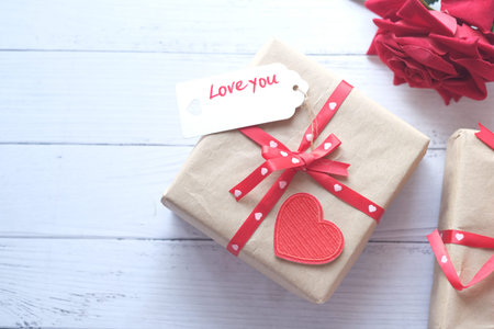 Top view of gift box, envelope and rose flower on white backgroundの写真素材