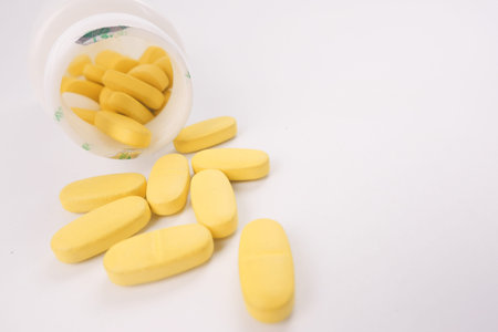 Close up of many vitamin pills on white background