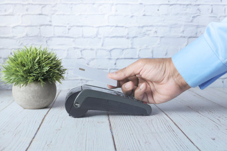 contactless payment concept with young man paying with credit card