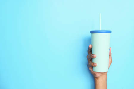 hand holding reusable eco coffee cup close upの写真素材
