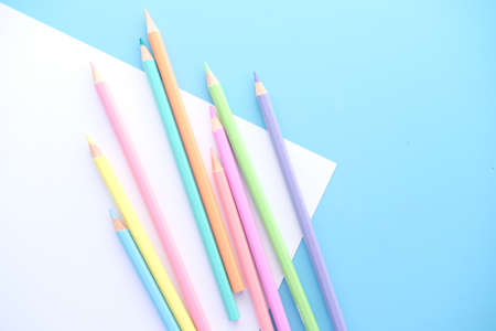 Close up of colorful pencils on empty paper, top downの写真素材