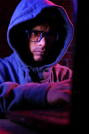 hacker hand stealing data from laptop top down