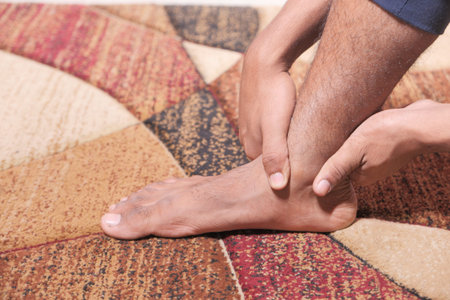 Close up young man suffering feet pain