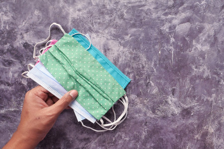 hand holding homemade face mask, top viewの写真素材