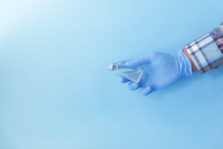 hand in latex gloves holding coronavirus vaccine, with copy spaceの写真素材
