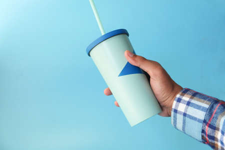 hand holding reusable eco coffee cup close upの写真素材