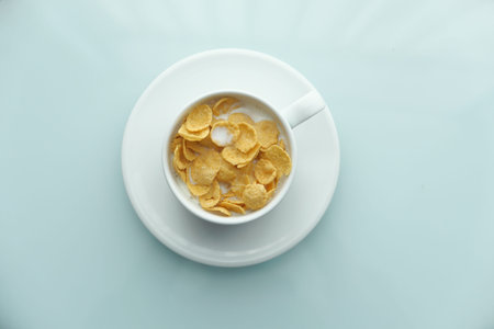 Top view of corn flakes in a bowl on table