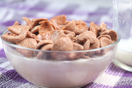 close up of chocolate flakes and milk on table