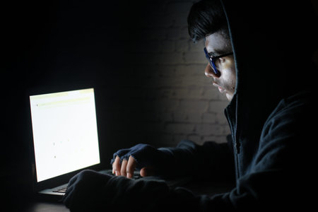 hacker hand stealing data from laptop top down