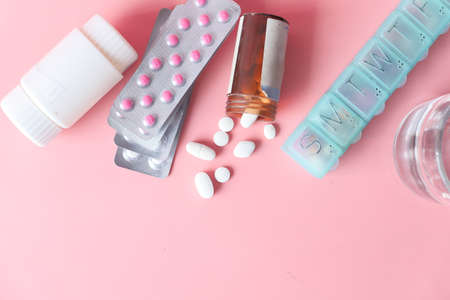 top view of pill box, pills and blister pack on pink backgroundの写真素材