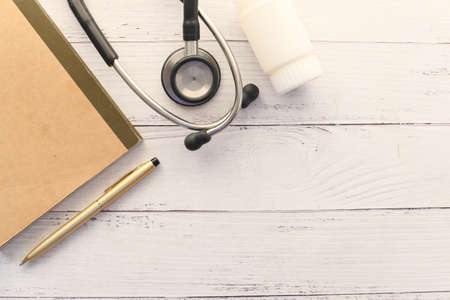 doctors workplace with container, keyboard and prescription on desk.の写真素材